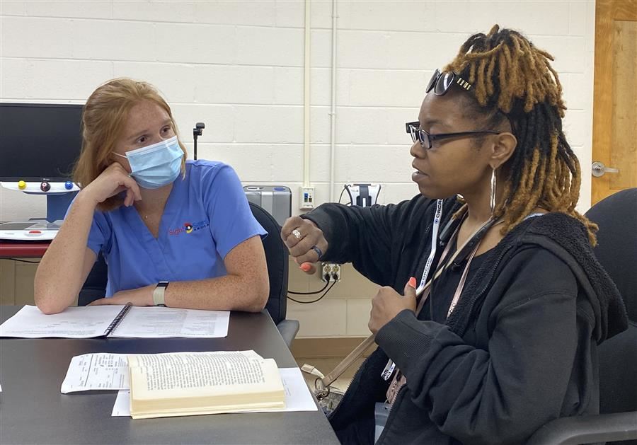  A student from E. H. Gentry works with Sight Savers America to try an Assistive Technology Device.